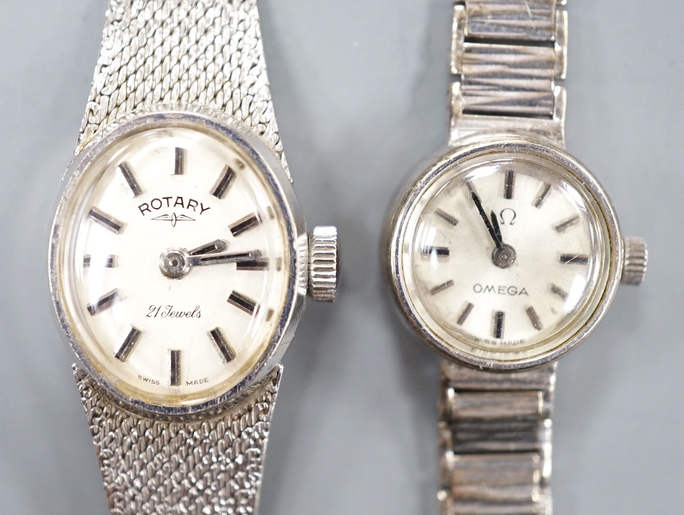 A lady's 9ct white gold Rotary manual wind wrist watch and a similar Omega wrist watch, gross 31.5 grams.